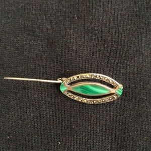 Green and silver pin